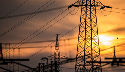 Electric utility in front of bright orange sky